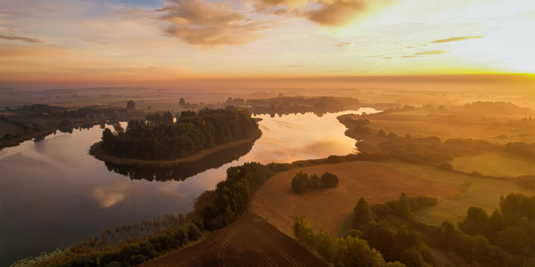 Jezioro i wyspy w złotym świetle — fotografia z drona Przemysława Właśniewskiego